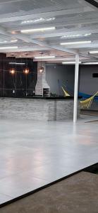 a room with a white floor in a building at Casa Alexandre in Goiânia