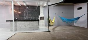 a large room with a wall with a flag on it at Casa Alexandre in Goiânia