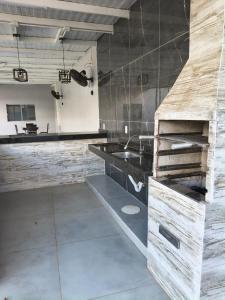a kitchen with a counter and a sink in a room at Casa Alexandre in Goiânia