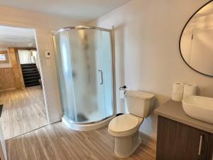 a bathroom with a shower and a toilet and a sink at Sir'Eau d'Érable in St-Ferdinand +30 photos