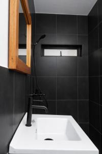 a bathroom with a white sink and a mirror at Ahomé Guest house & Lounge in Lomé +36 photos