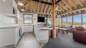 a kitchen and living room with a couch and a table at Eagles Nest in Mount Hotham +29 photos