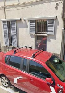 a red van parked in front of a building at Casa Maria - next Milano,Como, Varese in Caronno Pertusella