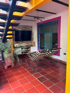 a living room with a table and chairs and a tv at Casa Roma in Rivera