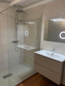 a bathroom with a shower and a sink and a mirror at Bidart centre maison vue mer in Bidart +16 photos