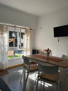 a dining room with a table and chairs and a window at The House in City Bell