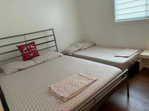 two twin beds in a room with a window at DREAM LAND Lake Front CHALET, HOT TUB in Huntingdon +44 photos