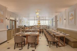 a large dining room with tables and chairs and a chandelier at The Fern Residency Jodhpur, Series by Marriott in Jodhpur
