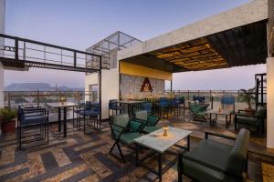 a restaurant with tables and chairs on a roof at The Fern Residency Jodhpur, Series by Marriott in Jodhpur