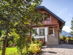 a wooden house with a balcony on top of it at Naturpark Chalet Schladming-Dachstein in Großsölk