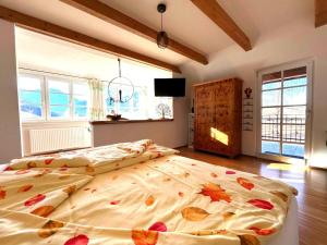 a bedroom with a large bed with leaves on it at Naturpark Chalet Schladming-Dachstein in Großsölk
