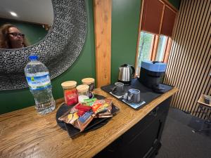 a counter with a bottle of water and food on it at El Grouso in Blenheim