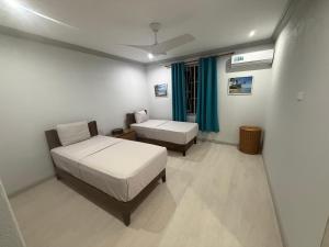 a bedroom with a bed and a couch in it at Mullins Bayfield Gardens House in Saint Peter