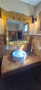 a bathroom with a sink and a large mirror at Sandy Shores Cabaña 10B in La Paz