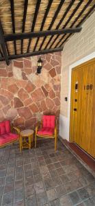 a patio with two benches and a table and a stone wall at Sandy Shores Cabaña 10B in La Paz +18 photos