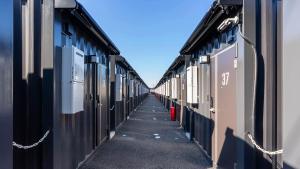 a row of trains parked next to each other at HOTEL R9 The Yard Mobaramutsuno in Machibo