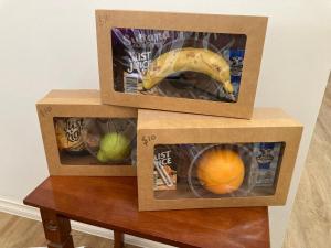 two boxes with fruit in them on a table at HOSTS offer HOME STAY on HIGH King Bed -- Private Home with Private Bathroom in Swan Hill