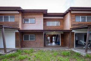 a brick house with the front door open at Rio - Destination Guyane in Macouria