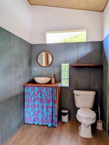 a bathroom with a sink and a toilet at ManaHenua Lodge in Nuku Hiva