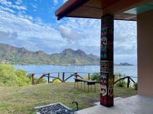 a view of a lake from a house with a bench at ManaHenua Lodge in Nuku Hiva +7 photos
