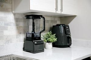 a kitchen counter with a blender and a coffee maker at Modern 1BR w/ Workspace near O'Hare in Chicago