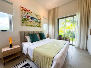 a bedroom with a large bed and a large window at Ki Resort Apartments & Penthouses by LOV Mauritius in Grand-Baie +128 photos