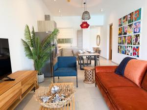 a living room with a couch and a table at Ki Resort Apartments & Penthouses by LOV Mauritius in Grand-Baie