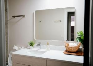a bathroom with a sink and a large mirror at Modern 1BR w/ Workspace near O'Hare in Chicago