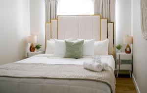 a bedroom with a large white bed with white pillows at Modern 1BR w/ Workspace near O'Hare in Chicago