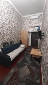 a bedroom with a bed and a table in it at Апартаменти в Центі Одеси in Odesa
