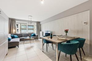 a living room with a table and a couch at Walter Vilain 0301 G in Sint-Idesbald