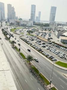 a highway with cars parked in a parking lot at A luxurious room with a breathtaking view in Sharjah