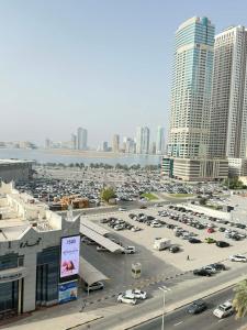 a parking lot in a city with tall buildings at A luxurious room with a breathtaking view in Sharjah