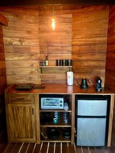 a small kitchen with a counter and a microwave at Naturave Monteverde - Treetop Cabins in Monteverde Costa Rica +39 photos