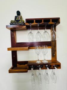 a wooden shelf with wine glasses on it at Celebirity garden 4 bhk -5 Bed Lulu and plassio mall gomti nagar in Lucknow