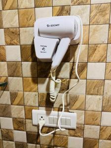 a hair dryer is plugged into a wall at Celebirity garden 4 bhk -5 Bed Lulu and plassio mall gomti nagar in Lucknow