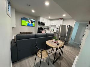 a living room with a couch and a table at Alake Villa in Saskatoon +20 photos