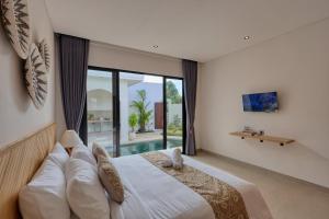 a bedroom with a large bed and a large window at Asaka Private Villa in Nusa Penida +38 photos
