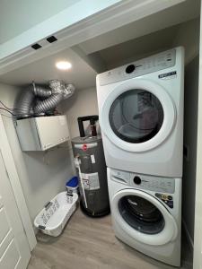 a washer and dryer in a laundry room with at Alake Villa in Saskatoon