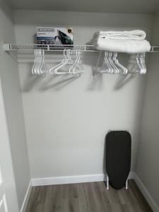 a closet with a glass shelf with towels on it at Alake Villa in Saskatoon