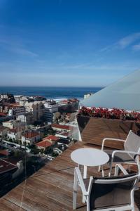 a balcony with a table and chairs on a building at Hotel Costa Verde in Póvoa de Varzim