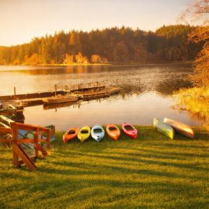 a group of kayaks sitting on the grass near a lake at Siltcoos Station in Siltcoos