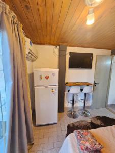 a small kitchen with a refrigerator and a table in a room at Departamento cómodo y renovado a pocas cuadras del parque mitre! in Corrientes +19 photos