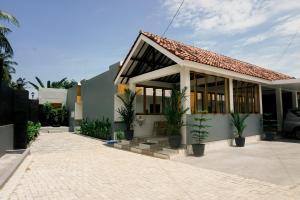a house with a lot of windows at The Umbu Stay Banyuwangi in Banyuwangi