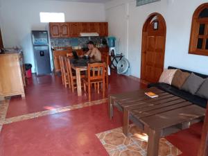 a man sitting at a table in a kitchen at Casa Tzipora in Brisas de Zicatela