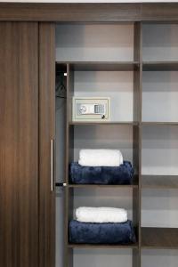 a walk in closet with two towels on shelves at Hotel Ivanna - Laureles in Medellín