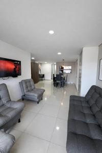a living room with couches and a dining room at Hotel Ivanna - Laureles in Medellín