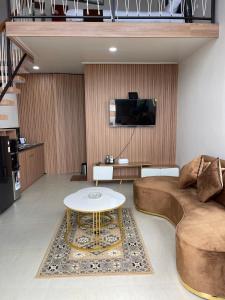 a living room with a couch and a table at Villa with Jacuzzi, Damar Ningrum 4 in Tutugan