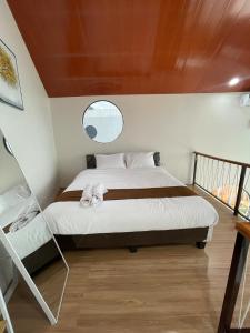 a bedroom with a large bed with a window at Villa with Jacuzzi, Damar Ningrum 4 in Tutugan