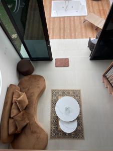 an overhead view of a living room with a table and a guitar at Villa with Jacuzzi, Damar Ningrum 4 in Tutugan +5 photos